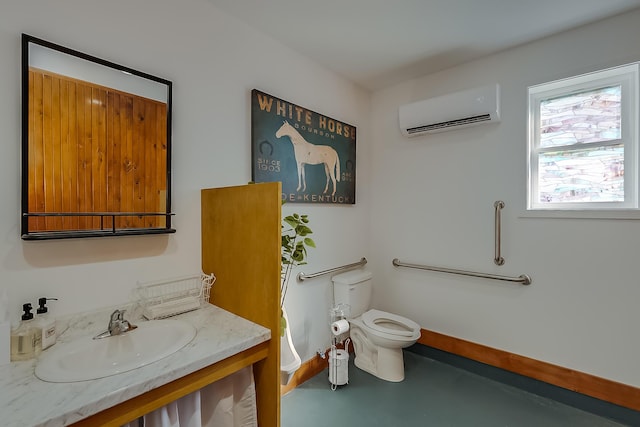 bathroom with toilet, vanity, concrete floors, and an AC wall unit