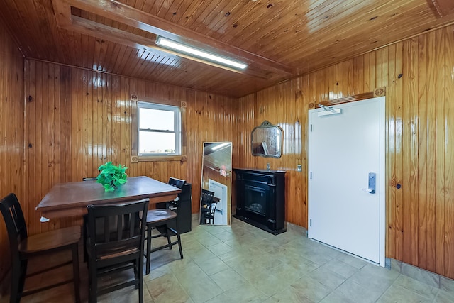 dining area featuring wood walls