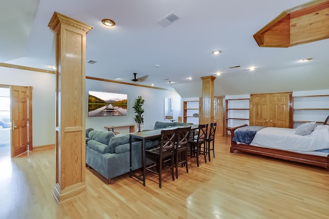 dining area featuring built in shelves, ceiling fan, light hardwood / wood-style flooring, decorative columns, and vaulted ceiling