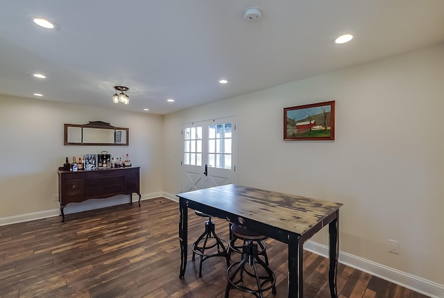 dining area with bar and dark wood-type flooring