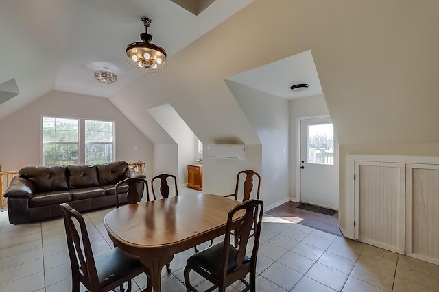 dining area featuring a wall mounted AC, plenty of natural light, lofted ceiling, and light tile patterned flooring