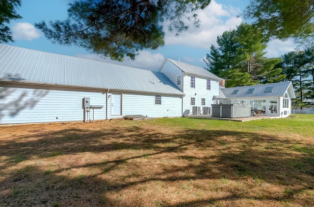 rear view of house featuring a yard and a patio area