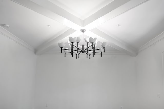 interior details with beam ceiling and a chandelier