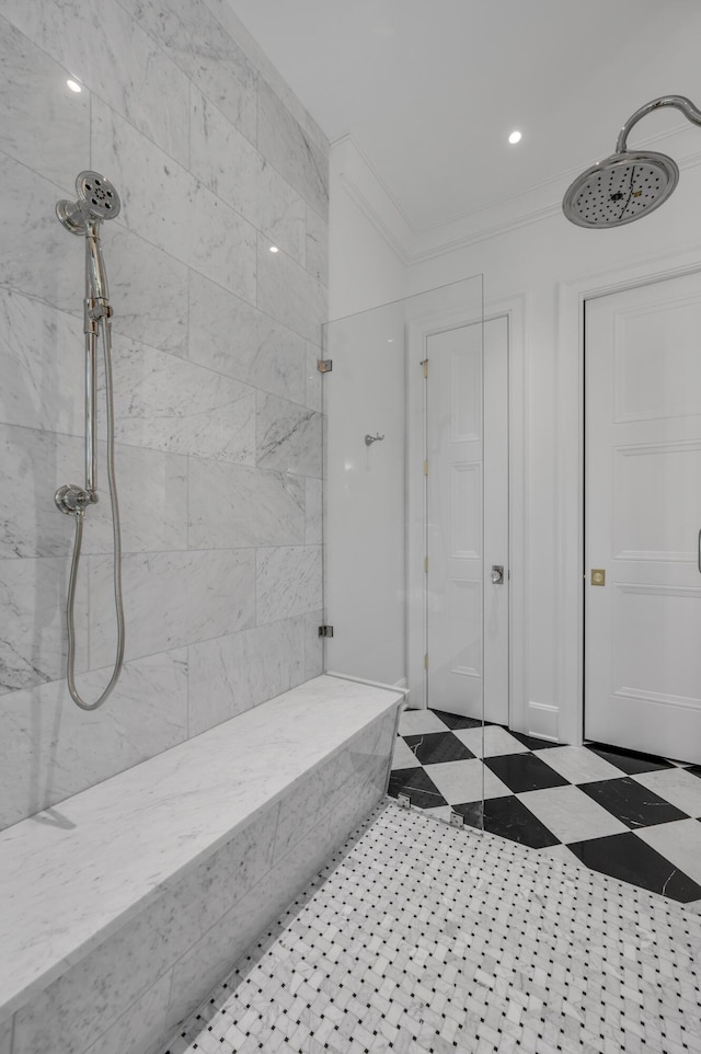 bathroom with a tile shower and crown molding