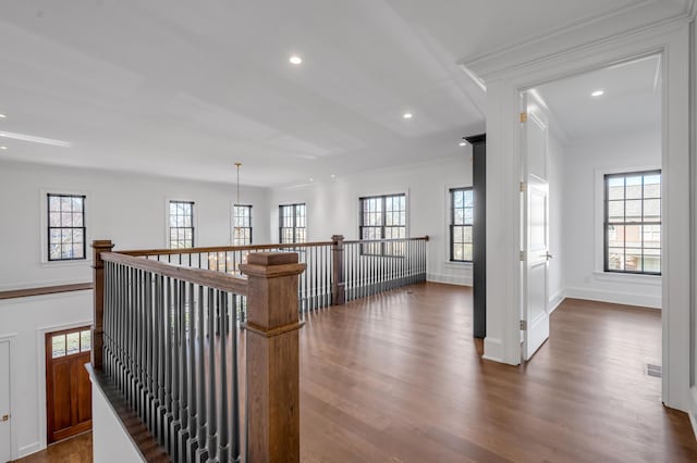 corridor with dark hardwood / wood-style flooring and ornamental molding