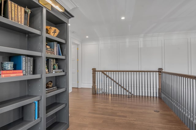 hallway with hardwood / wood-style floors and built in features