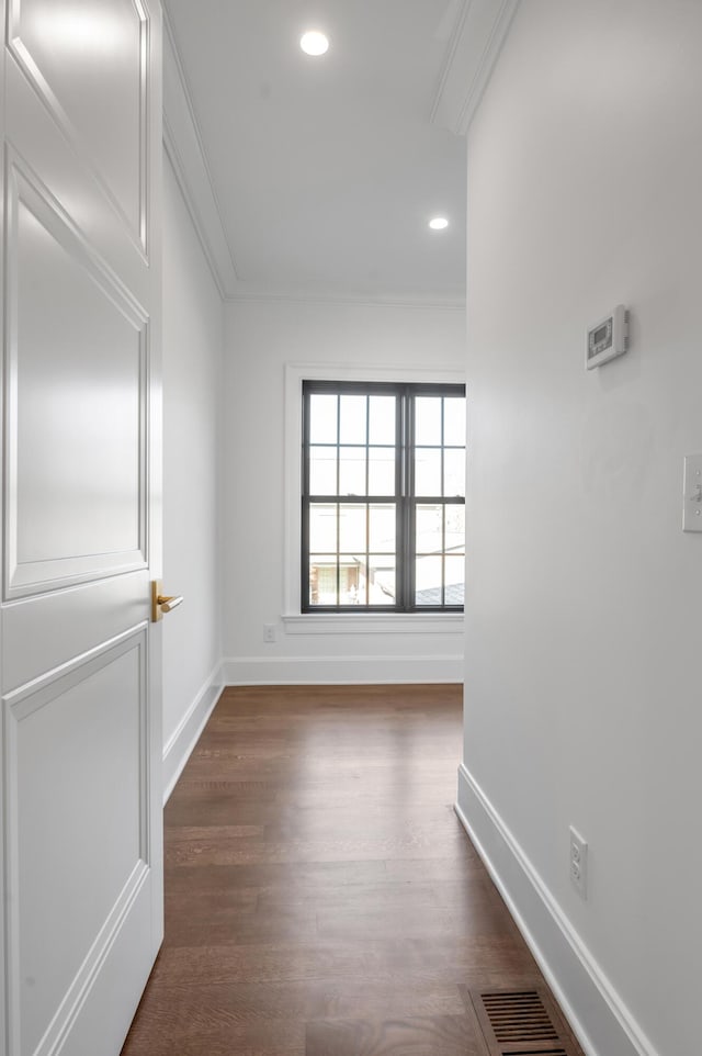 interior space featuring crown molding and dark wood-type flooring