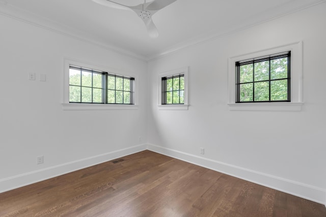 empty room featuring ceiling fan, ornamental molding, and hardwood / wood-style flooring