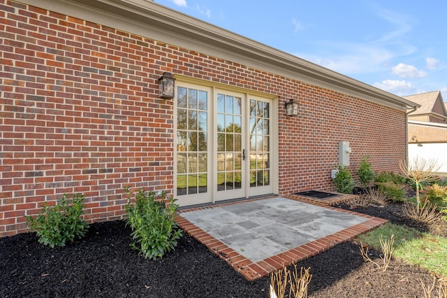 view of exterior entry with a patio