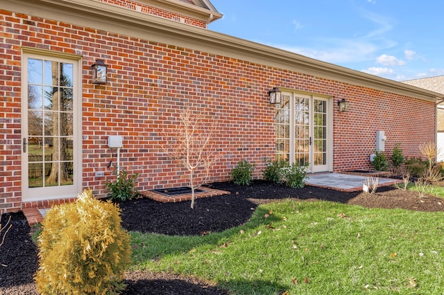 doorway to property featuring a lawn