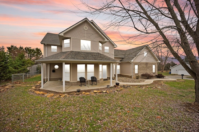 view of front of property with a lawn and a patio