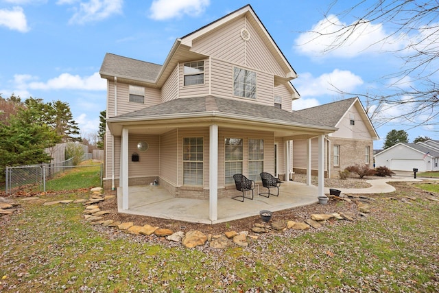 back of house featuring a lawn and a patio