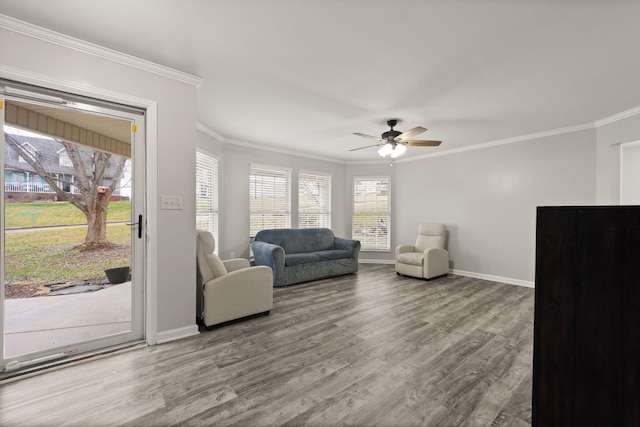 living room with ceiling fan, crown molding, and wood-type flooring