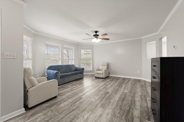 living room with ceiling fan, light wood-type flooring, and crown molding