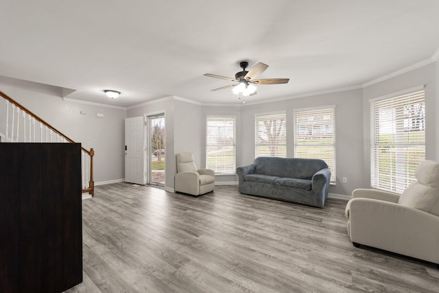 living room with ceiling fan, light hardwood / wood-style flooring, and ornamental molding