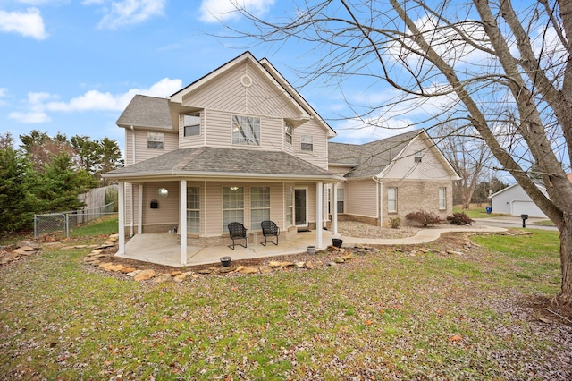 rear view of property with a lawn and a patio area