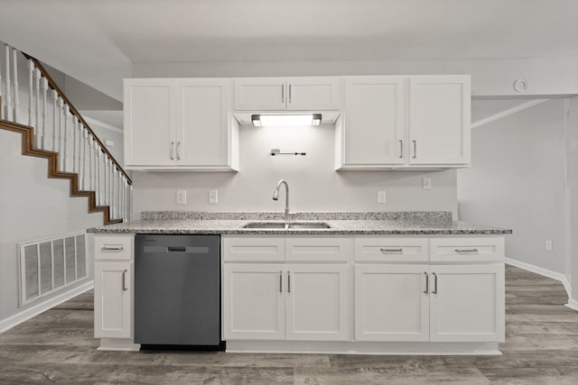 kitchen with white cabinetry, sink, stainless steel dishwasher, and light stone counters