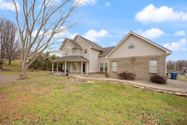 view of front of property with a porch and a front lawn