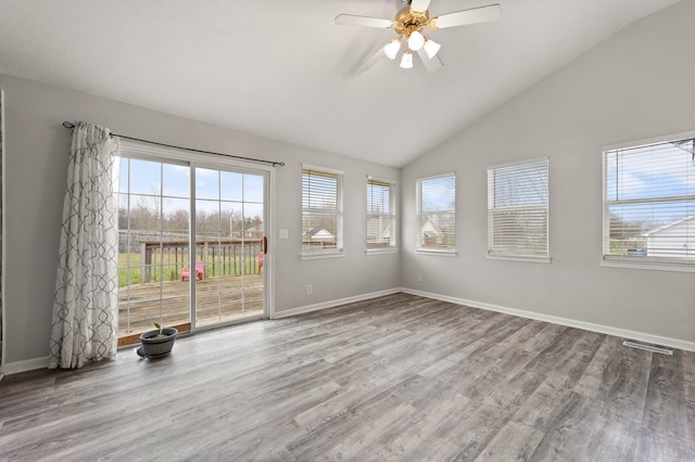 unfurnished room with ceiling fan, vaulted ceiling, and hardwood / wood-style flooring