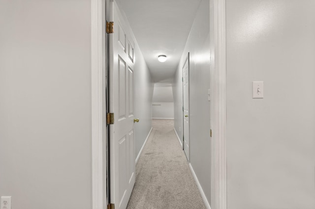 hall with light colored carpet