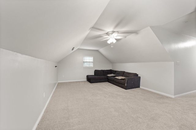 additional living space featuring light colored carpet, vaulted ceiling, and ceiling fan