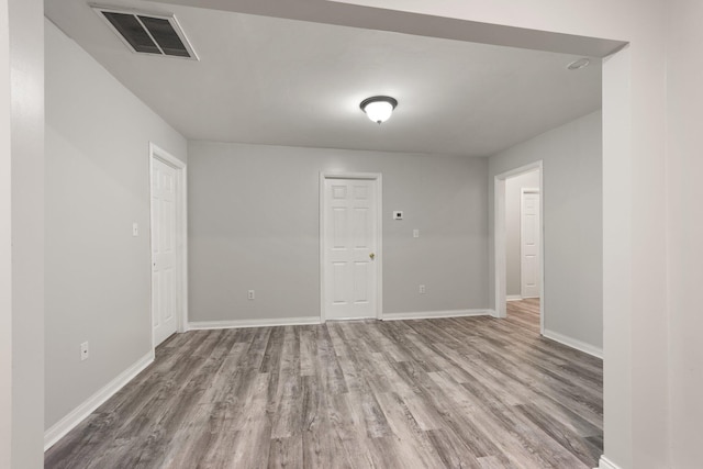 empty room with hardwood / wood-style floors