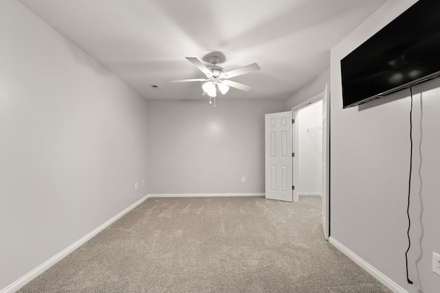 empty room featuring light carpet and ceiling fan