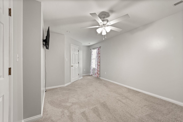 unfurnished bedroom with ceiling fan and light carpet