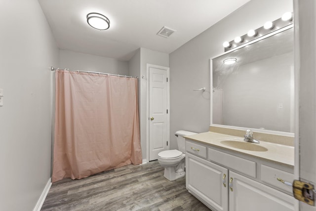 bathroom featuring vanity, curtained shower, toilet, and wood-type flooring