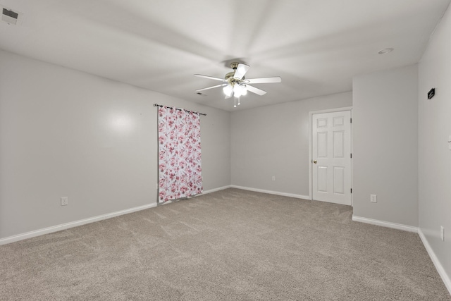 spare room with carpet and ceiling fan