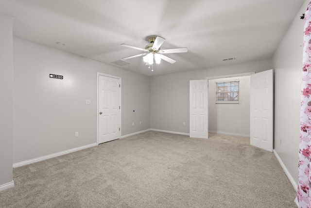 unfurnished bedroom featuring ceiling fan and light carpet