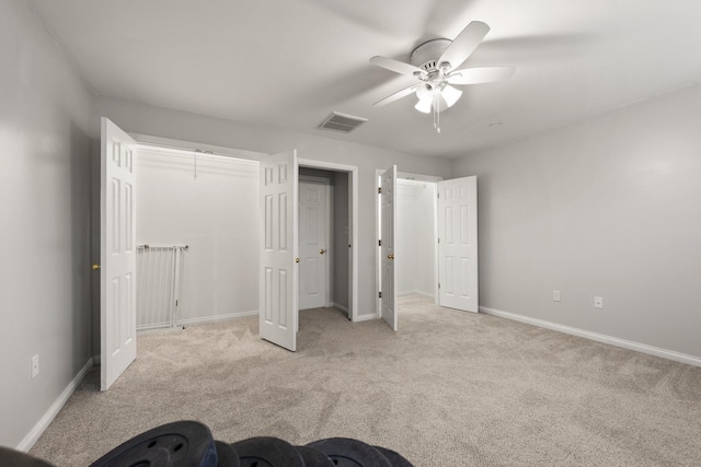 unfurnished bedroom with ceiling fan and light colored carpet