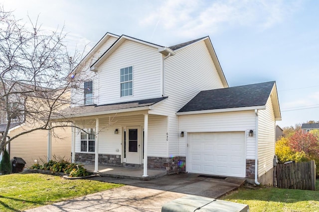 view of front facade featuring covered porch, a garage, and a front lawn