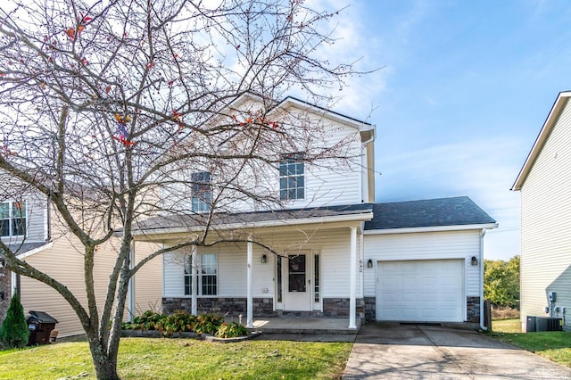 front facade featuring covered porch, a garage, and a front lawn