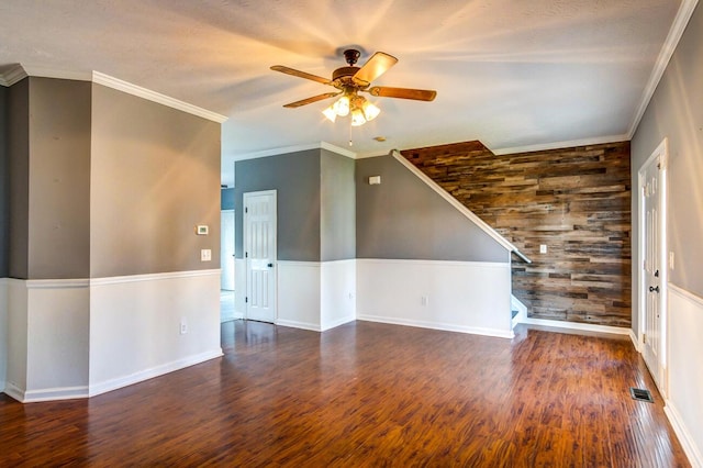 unfurnished room with ceiling fan, crown molding, and dark wood-type flooring