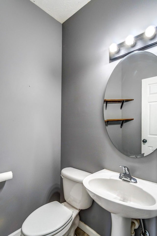 bathroom featuring sink and toilet