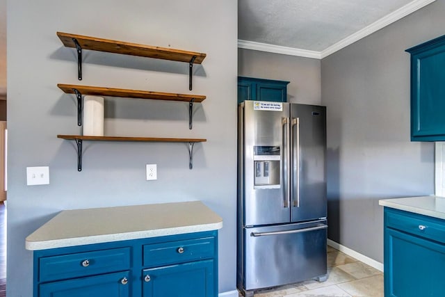 kitchen featuring stainless steel fridge, light tile patterned floors, blue cabinets, and ornamental molding