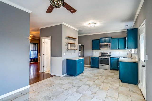 kitchen with appliances with stainless steel finishes, blue cabinets, a healthy amount of sunlight, and sink