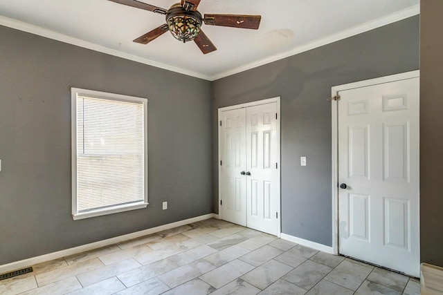 unfurnished bedroom featuring light tile patterned floors, a closet, ceiling fan, and crown molding