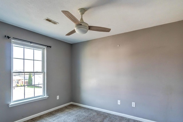 empty room featuring carpet floors and ceiling fan