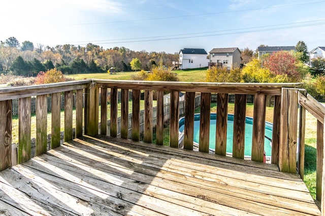 wooden deck featuring a swimming pool