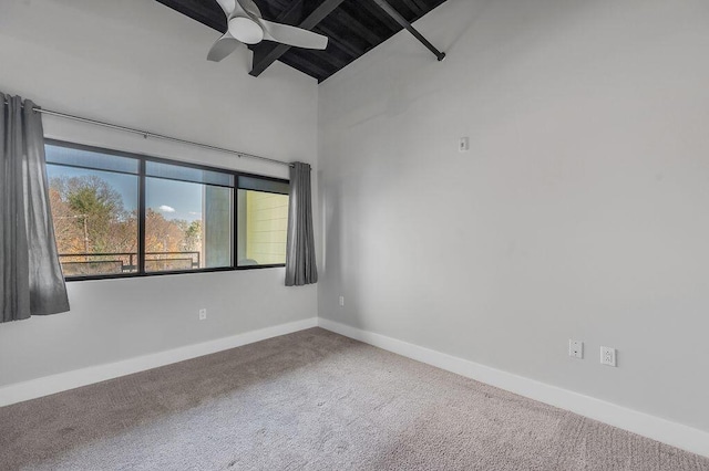 unfurnished room with ceiling fan, carpet floors, and high vaulted ceiling