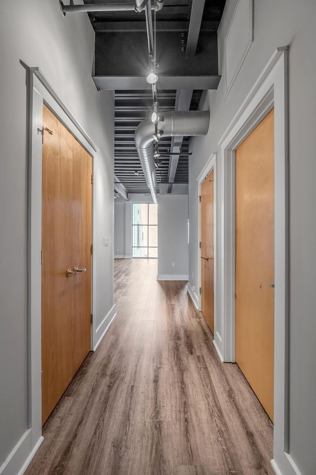 corridor featuring wood-type flooring