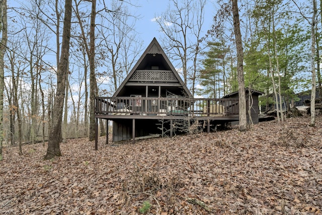 rear view of property with a wooden deck