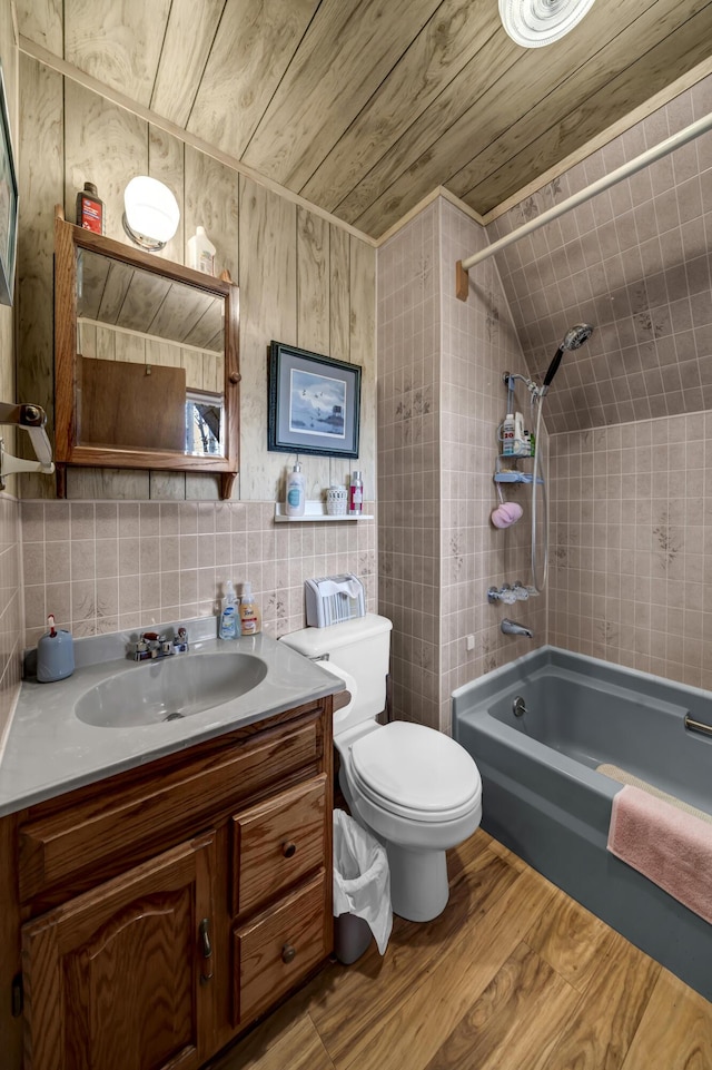 full bathroom featuring vanity, wooden ceiling, tiled shower / bath, toilet, and wood-type flooring