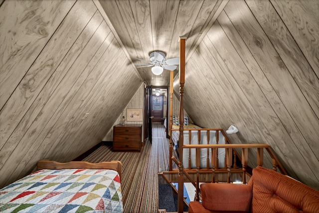 bedroom featuring ceiling fan, wooden walls, wood ceiling, and vaulted ceiling