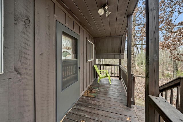 wooden terrace with covered porch and ceiling fan