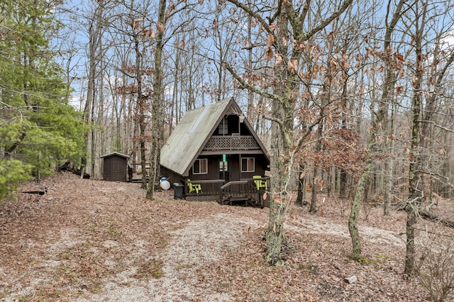 view of front facade with covered porch and a storage shed