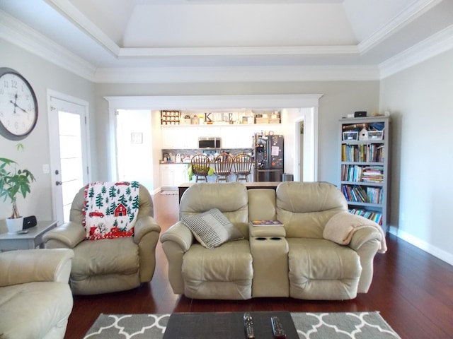 living room featuring dark hardwood / wood-style floors, a tray ceiling, and crown molding