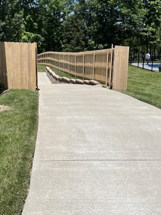 view of gate with a yard